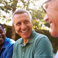 mature man happily talking to friends  