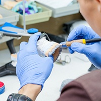 a lab technician making the teeth for dentures