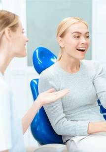 a patient checking her smile with a mirror